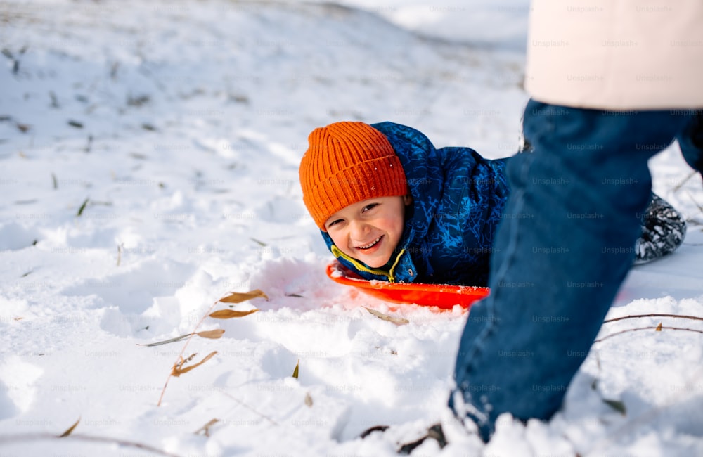 a young boy is playing in the snow
