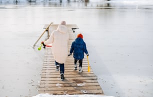 a woman and a child walking on a dock