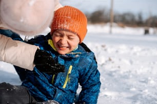 a young boy is playing in the snow