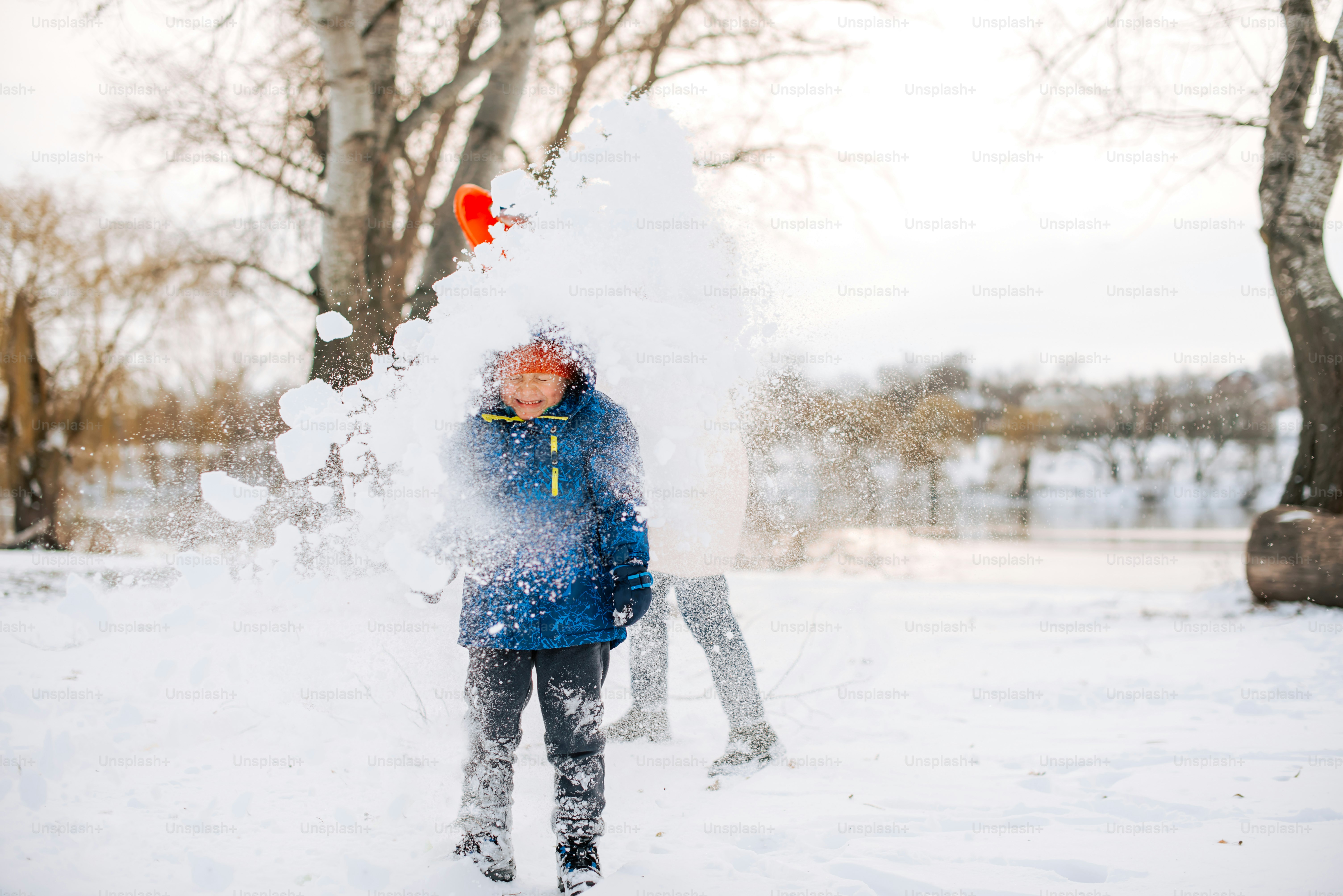 a woman is throwing snow in the air