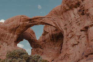 a large rock formation with an arch in the middle of it