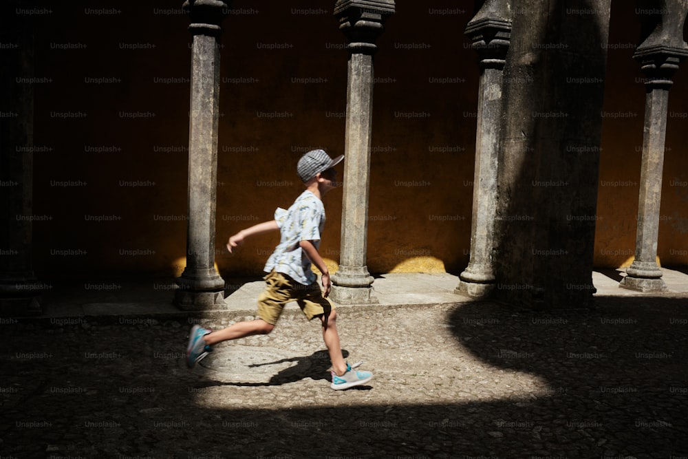 a young man is running through a courtyard