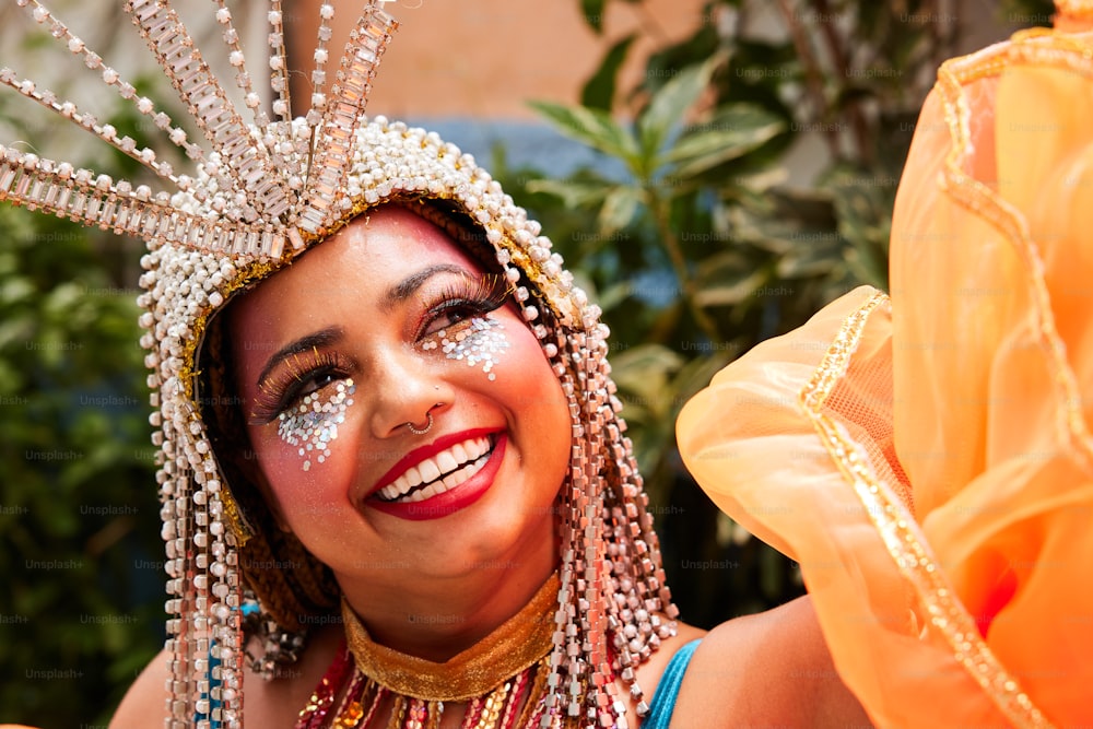 a woman wearing a headdress and smiling for the camera