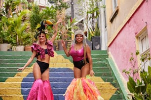 two women in bikinis standing on a set of stairs