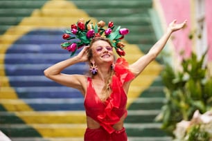 a woman in a red dress with a flower crown on her head