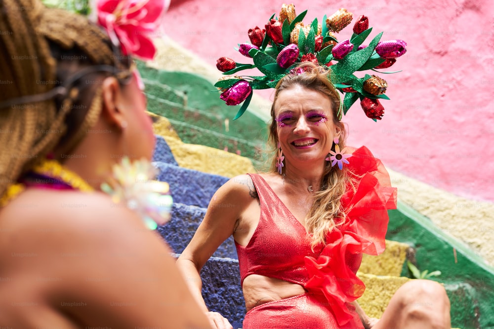 a woman wearing a red dress and a flower headpiece