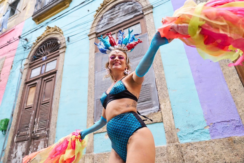 a woman in a bikini holding a colorful umbrella