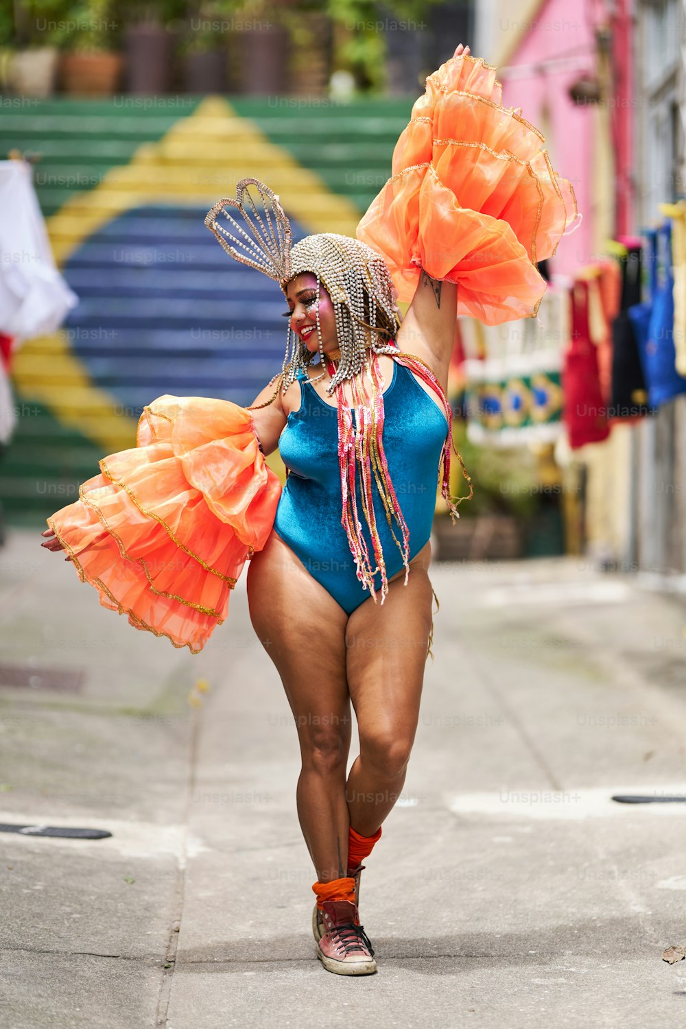 a woman in a blue swimsuit with orange wings