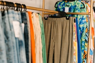 a rack of pants hanging on a clothes rack