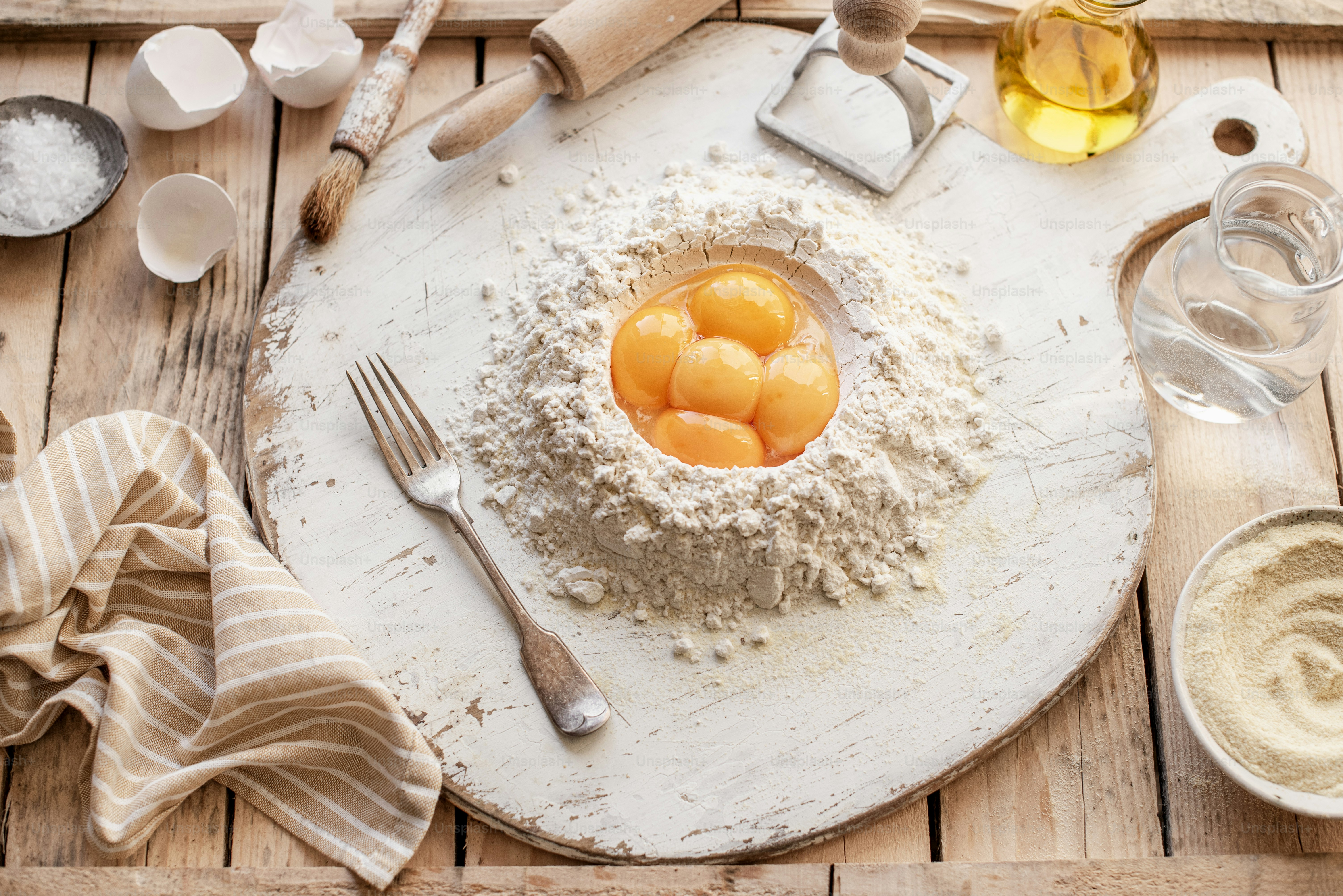 A table topped with a bowl of food and utensils photo – Eggs Image on ...