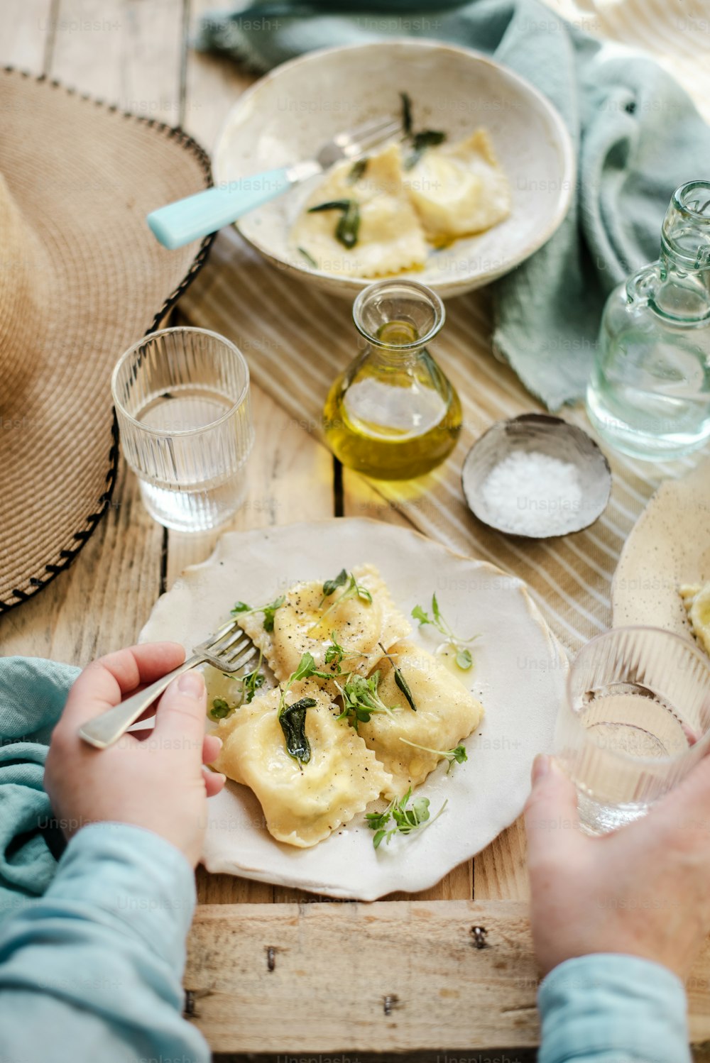 a person sitting at a table with a plate of food