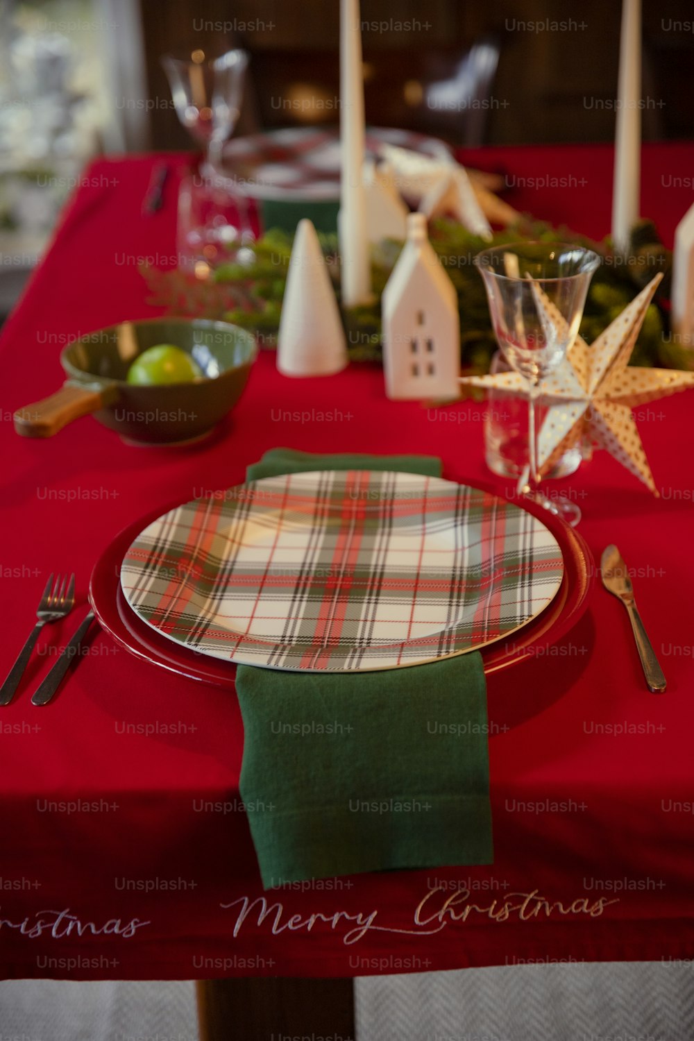 a christmas table setting with a red table cloth
