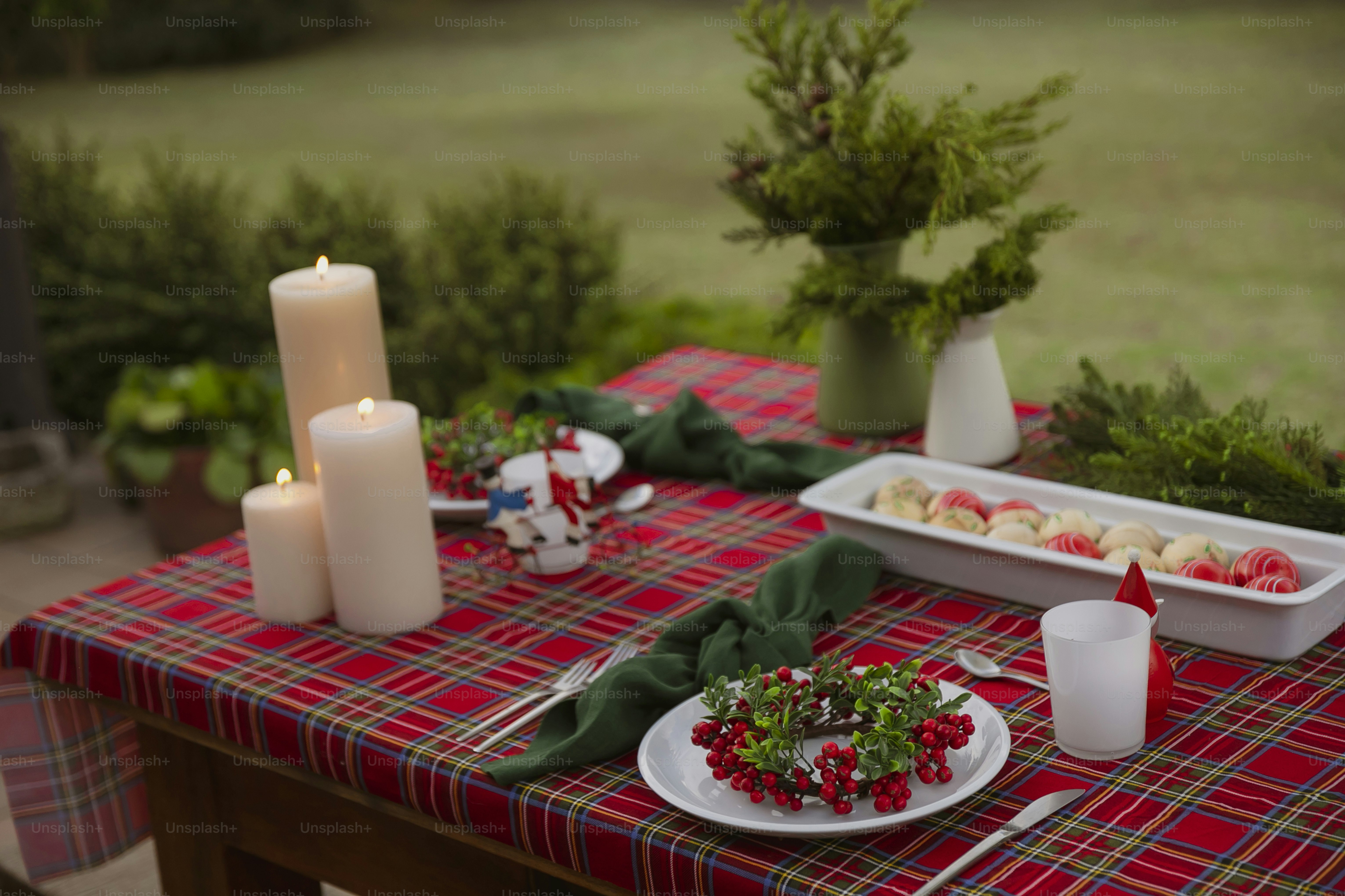 a table topped with plates of food and candles