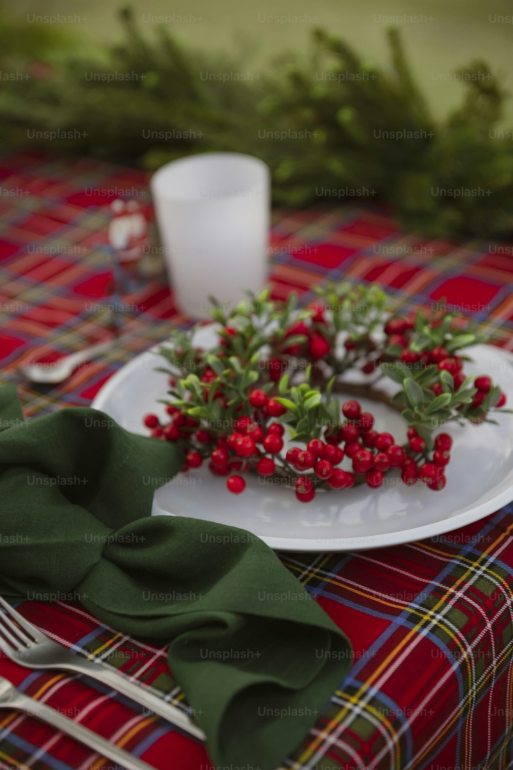 a white plate topped with red berries on top of a table