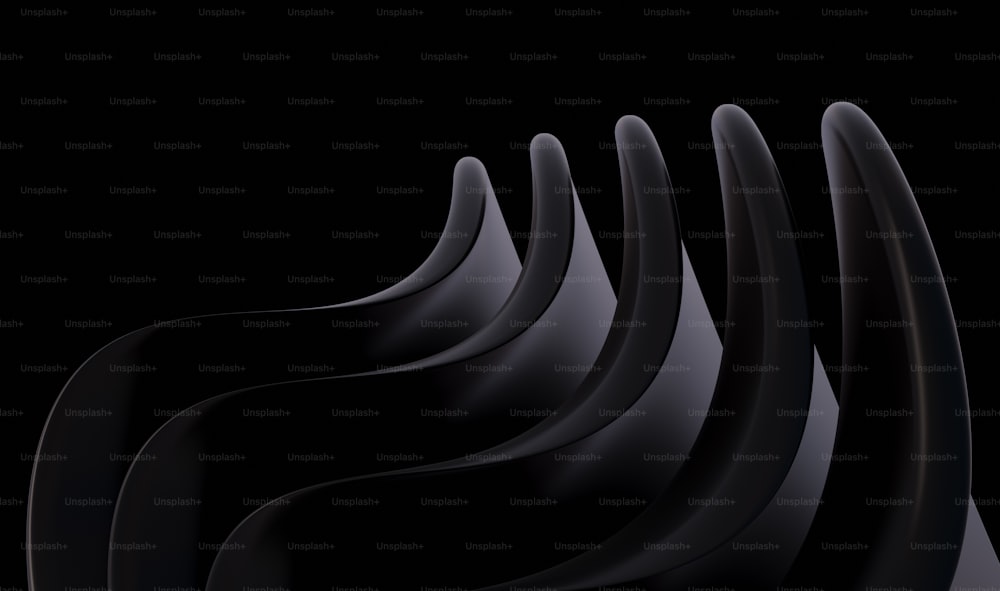 a group of black wavy shapes on a black background