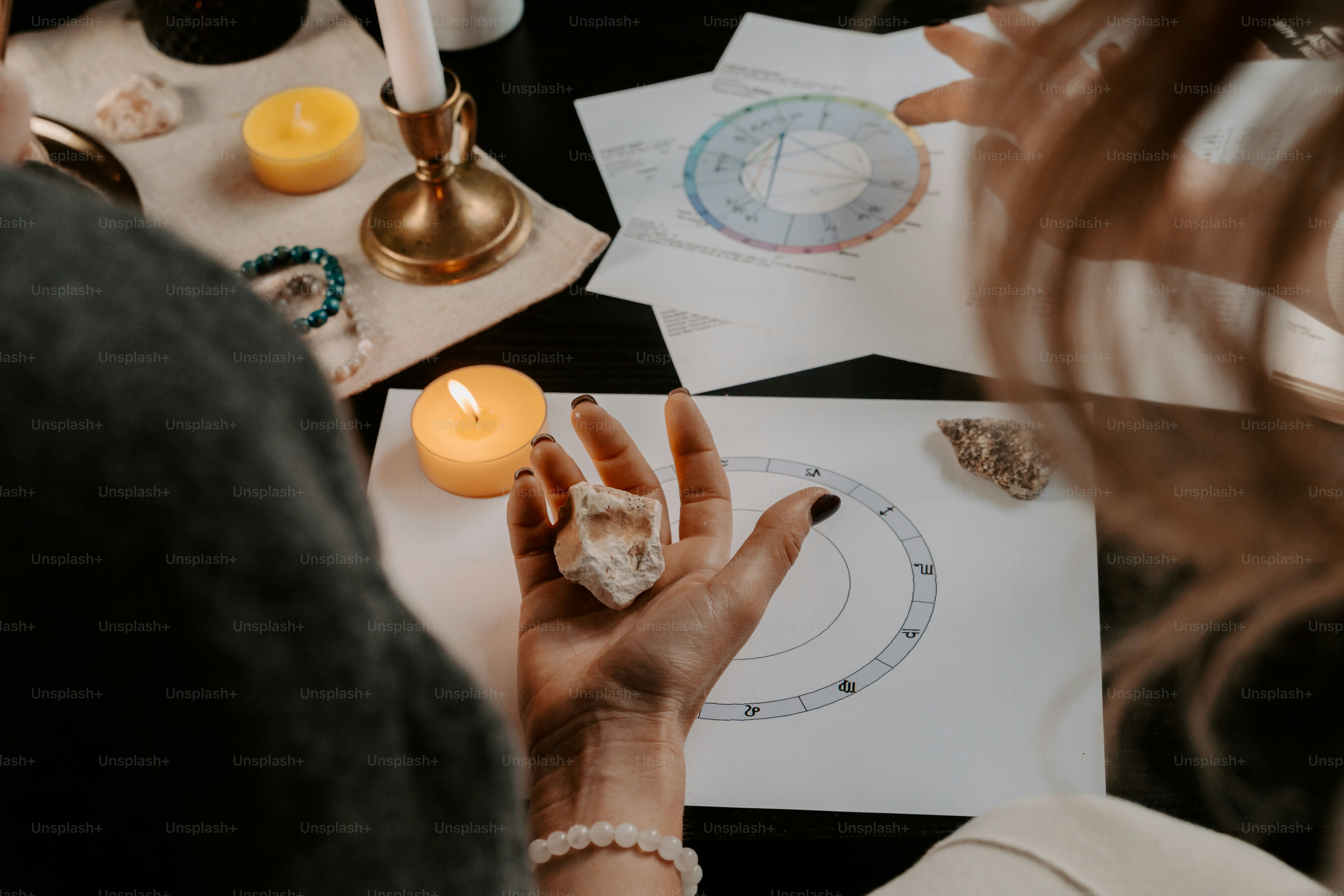 a woman sitting at a table working on a project
