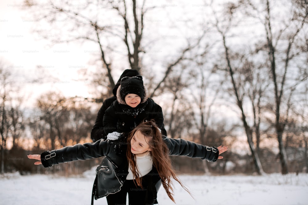 two young girls are playing in the snow