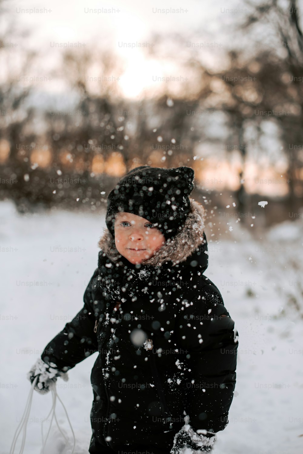a young child is playing in the snow