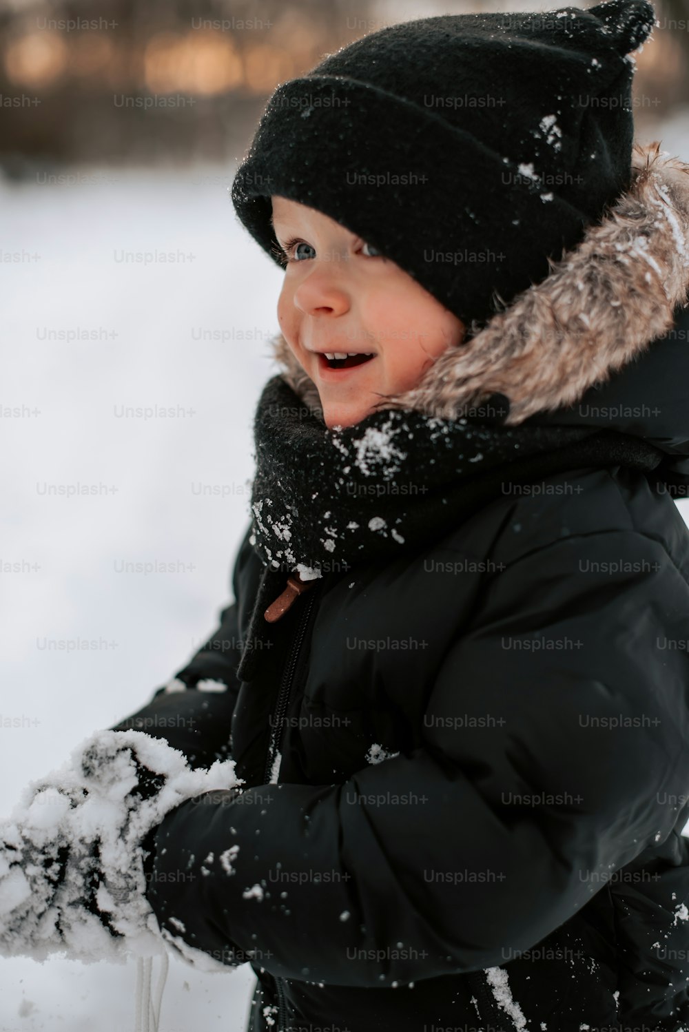 a young boy playing in the snow