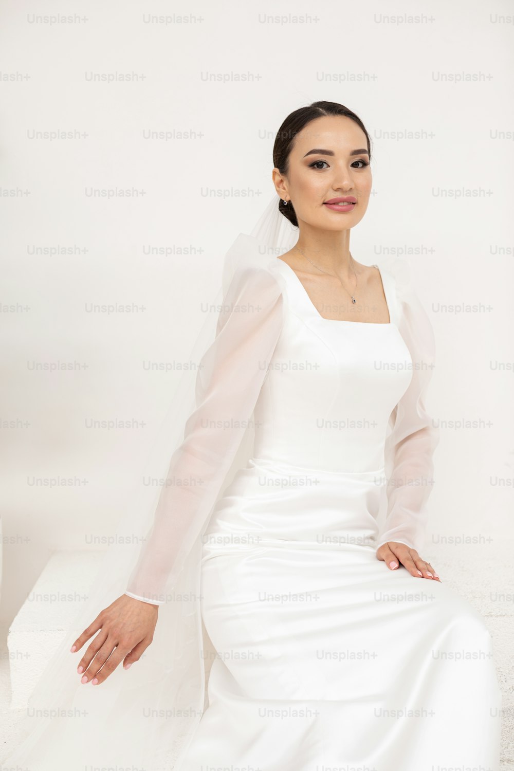 a woman in a white wedding dress posing for a picture