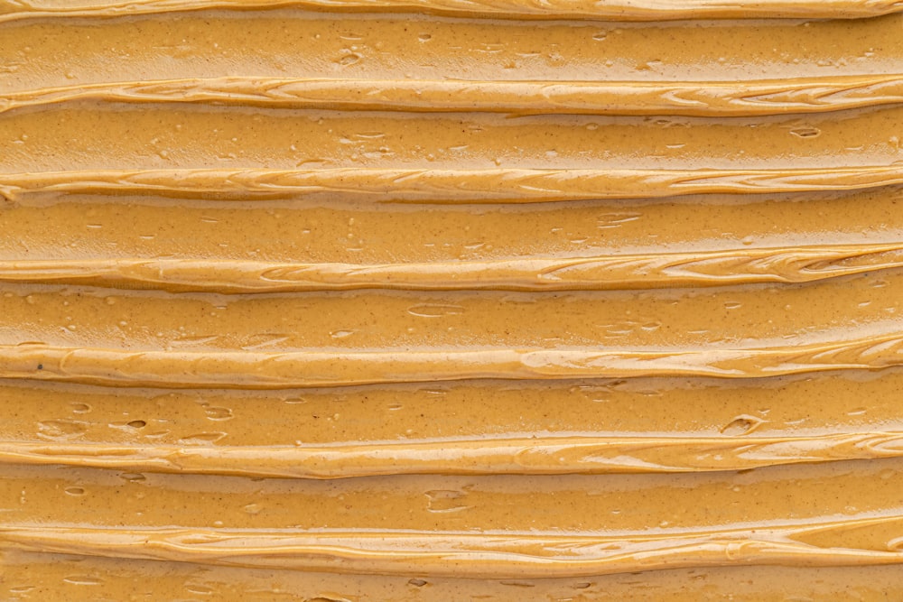 a close up of a cake with yellow frosting