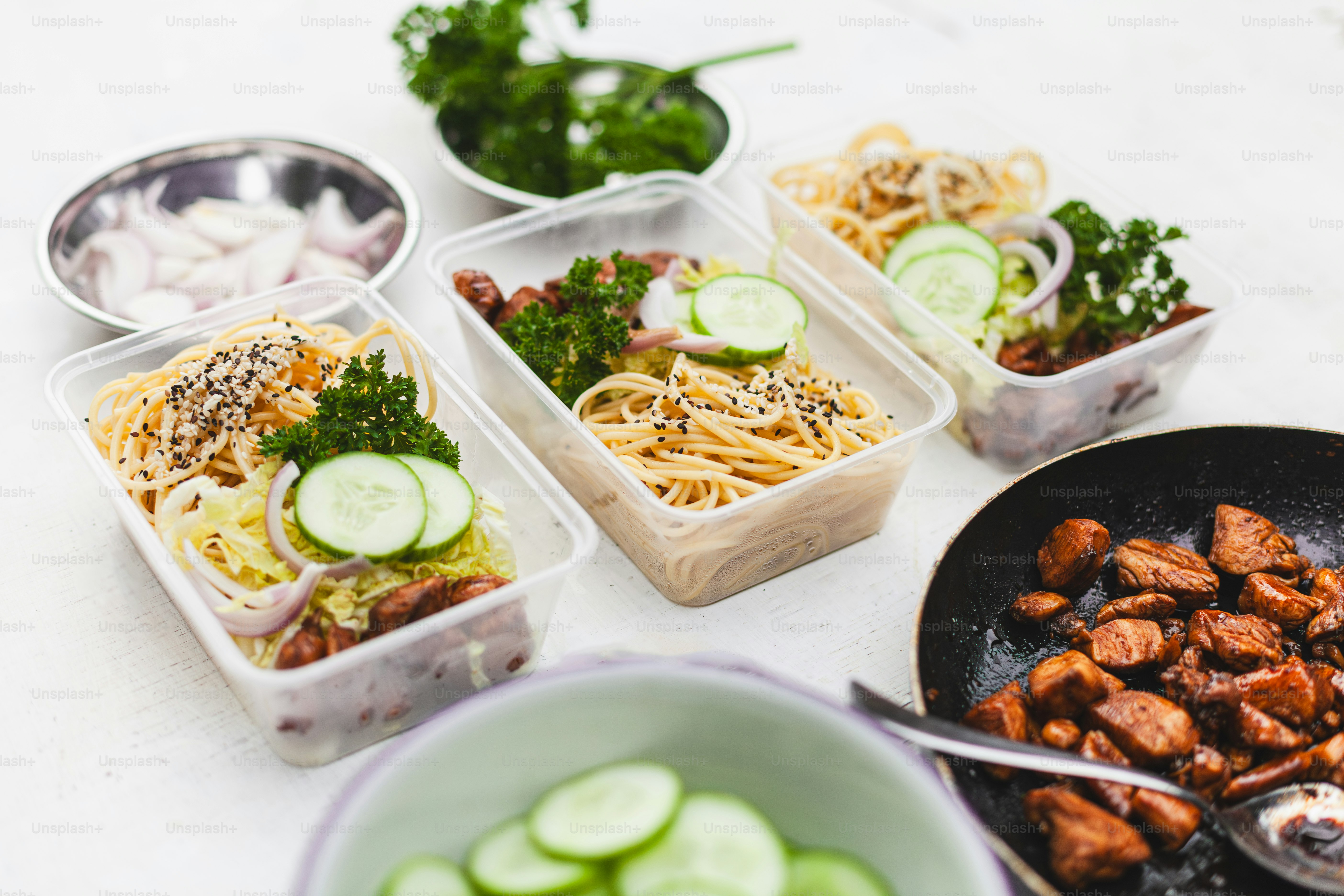 Three plastic containers filled with food on top of a table photo ...