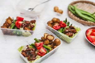 three plastic containers filled with different types of food