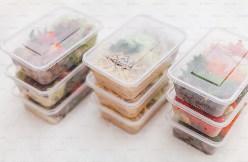 a group of plastic containers filled with food