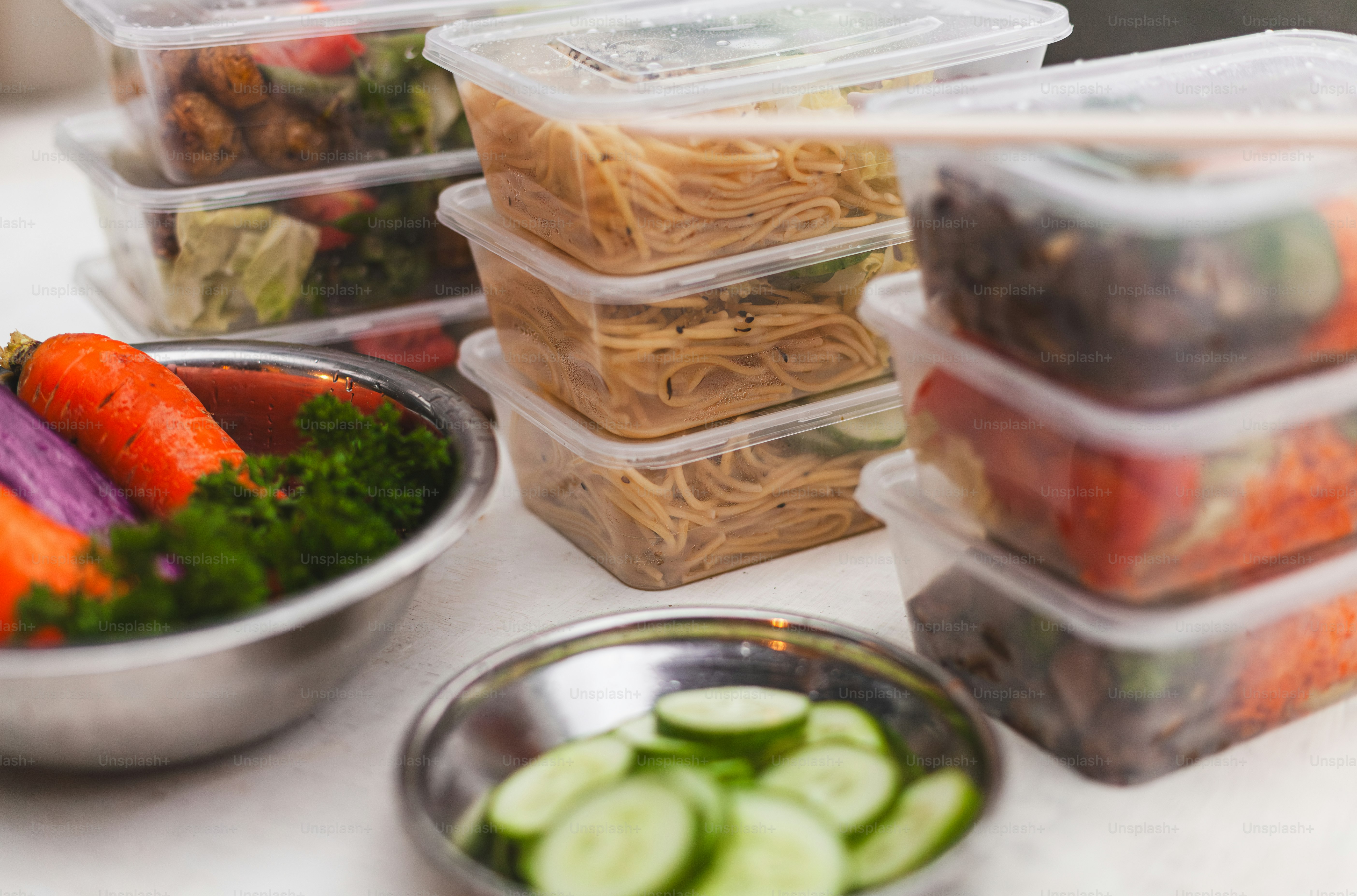 A table topped with plastic containers filled with food photo – Healthy ...