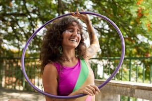 a woman in a bikini holding a hoop