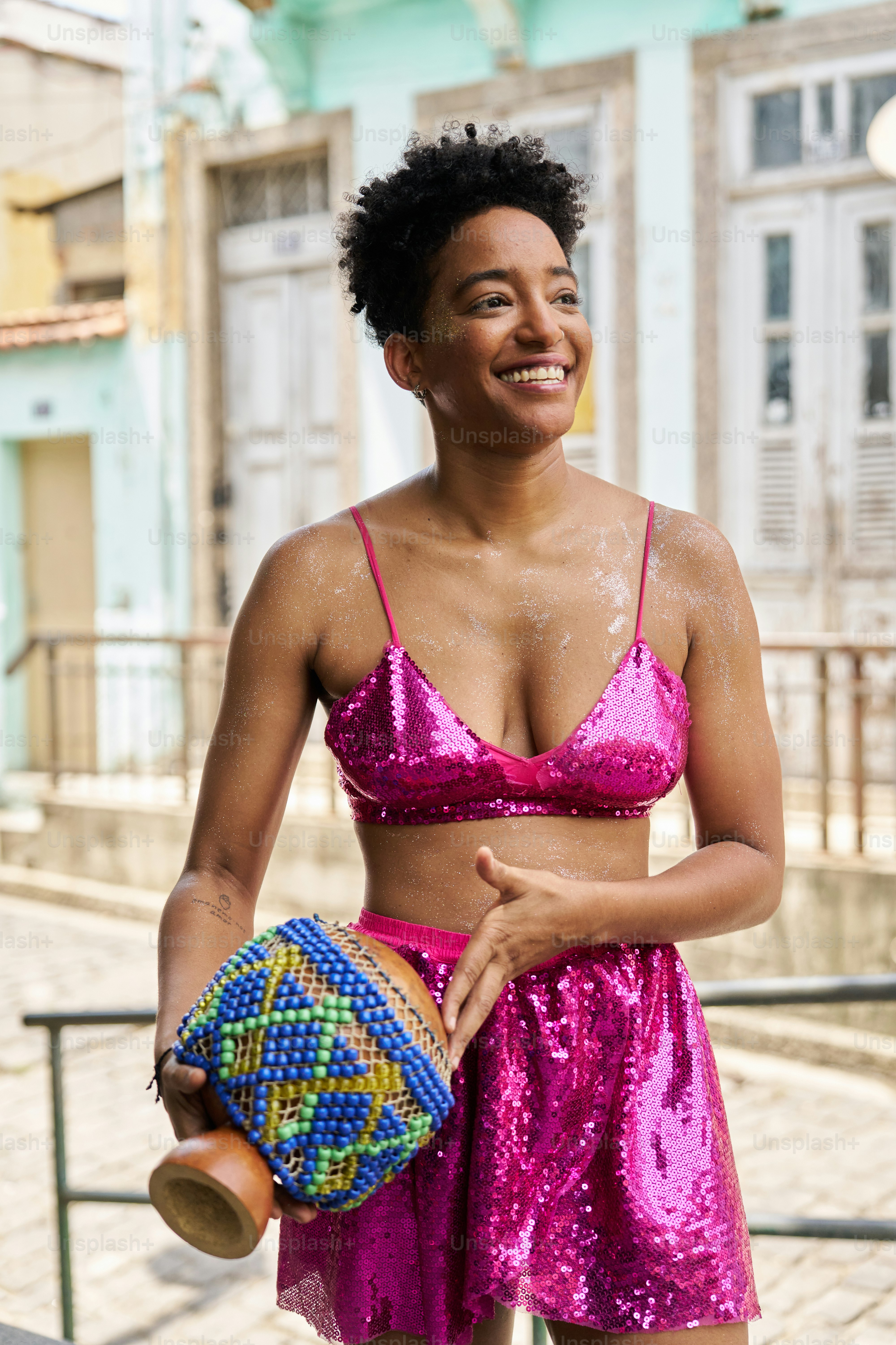 a woman in a pink bikini top and shorts