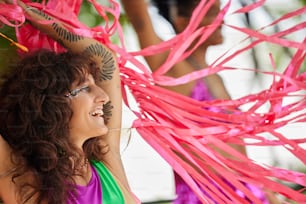 a woman in a green top and pink streamers
