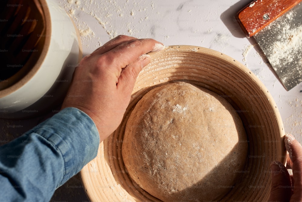 a person is making a bread in a bowl