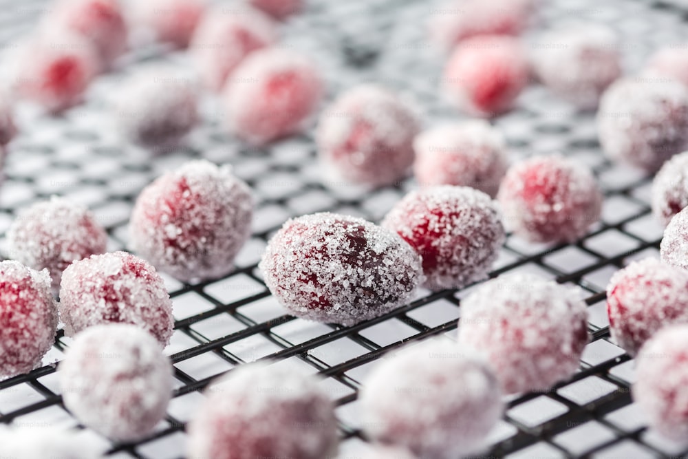 a bunch of powdered sugar balls sitting on a cooling rack