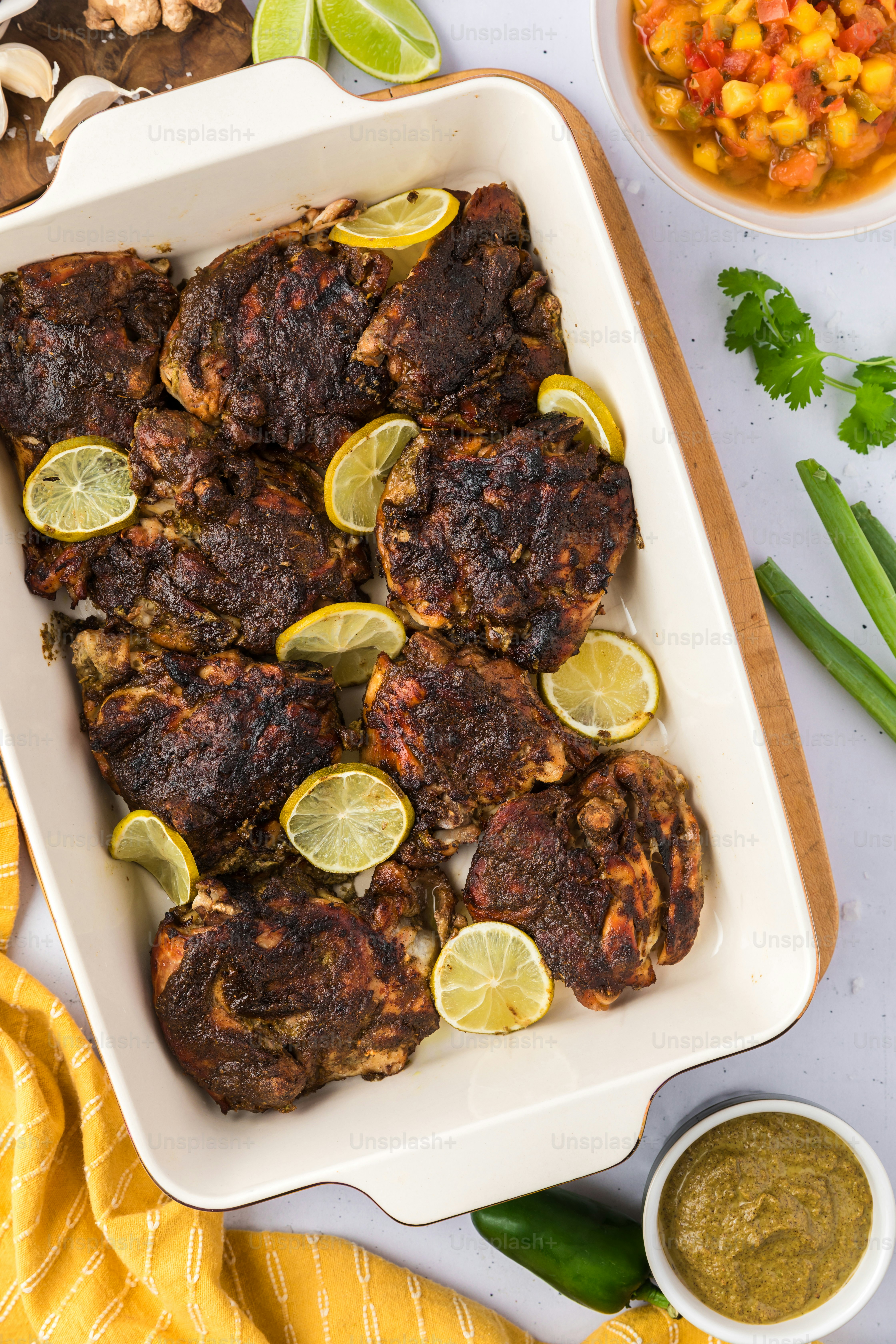 a dish of chicken with lemons and green beans