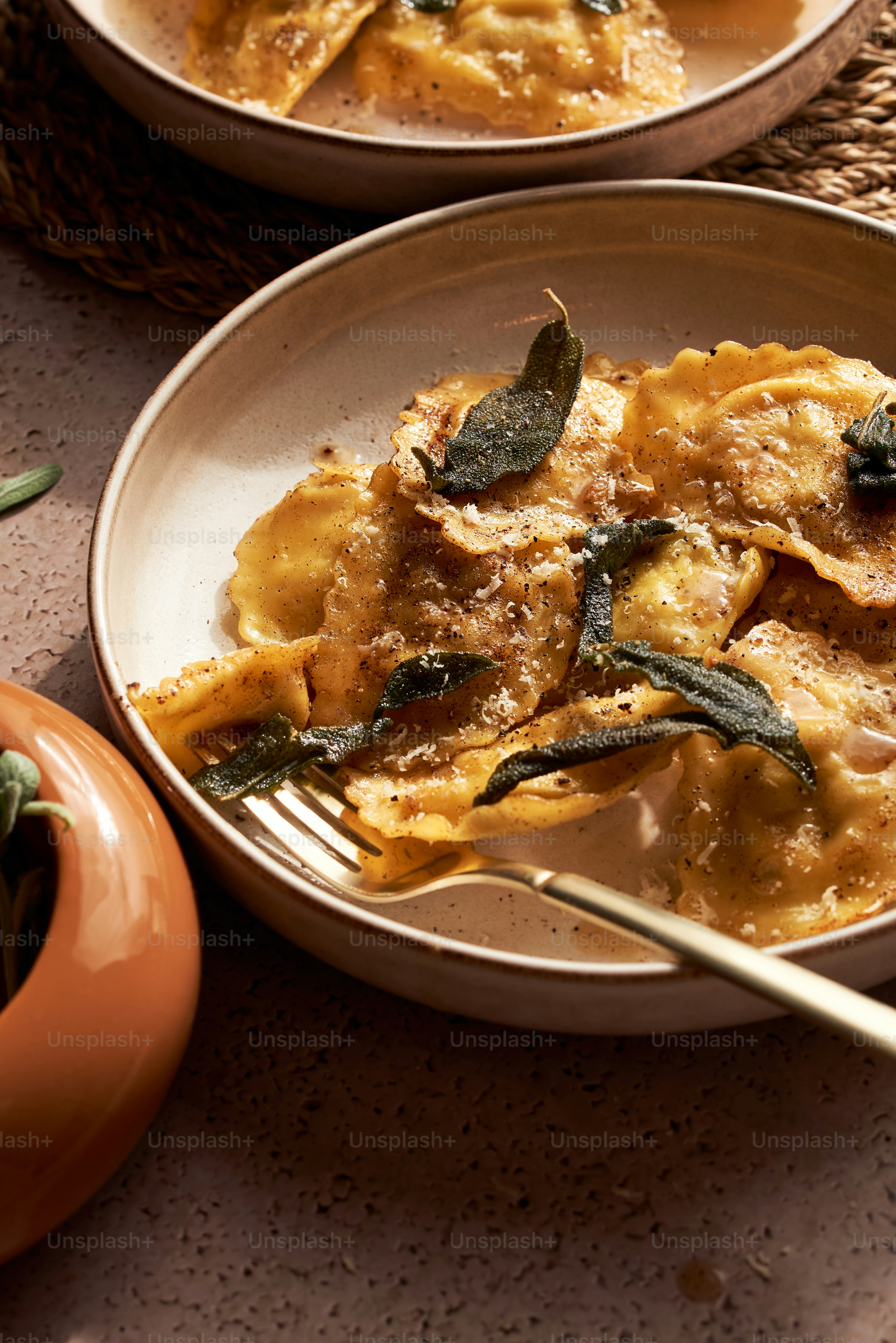 a plate of ravioli with spinach and cheese