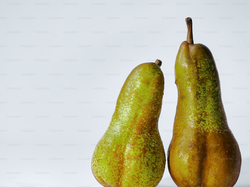 a couple of pears sitting next to each other