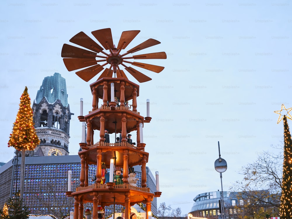 a large wooden clock tower sitting in the middle of a street