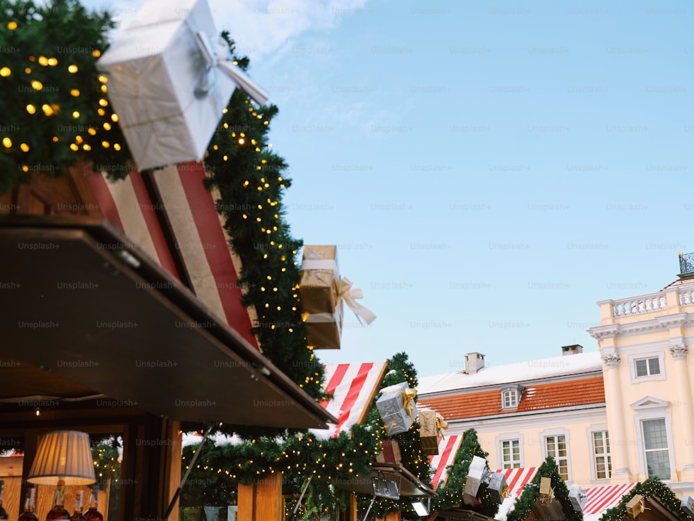 a large christmas tree with lights on it in front of a building