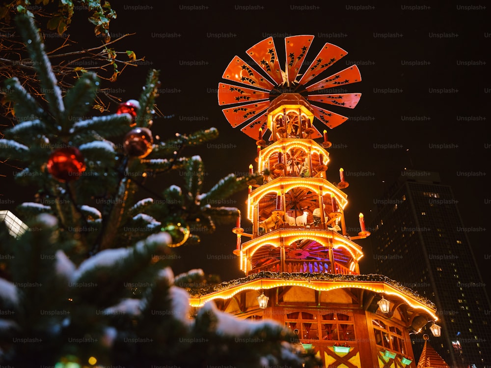 a christmas tree with a ferris wheel in the background