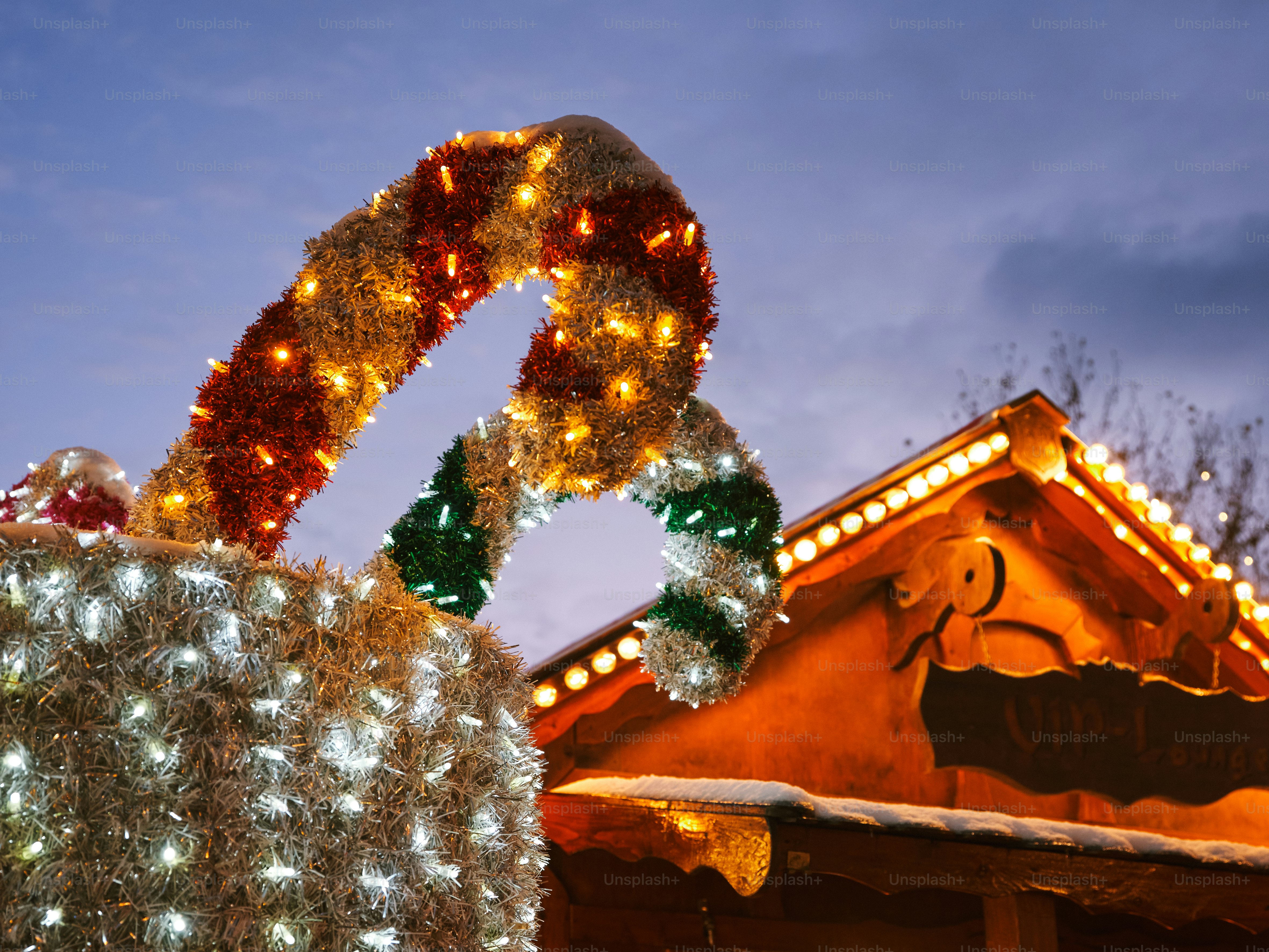 a christmas display with lights and decorations on top of a building