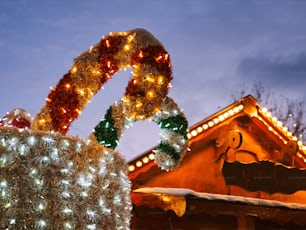 a christmas display with lights and decorations on top of a building