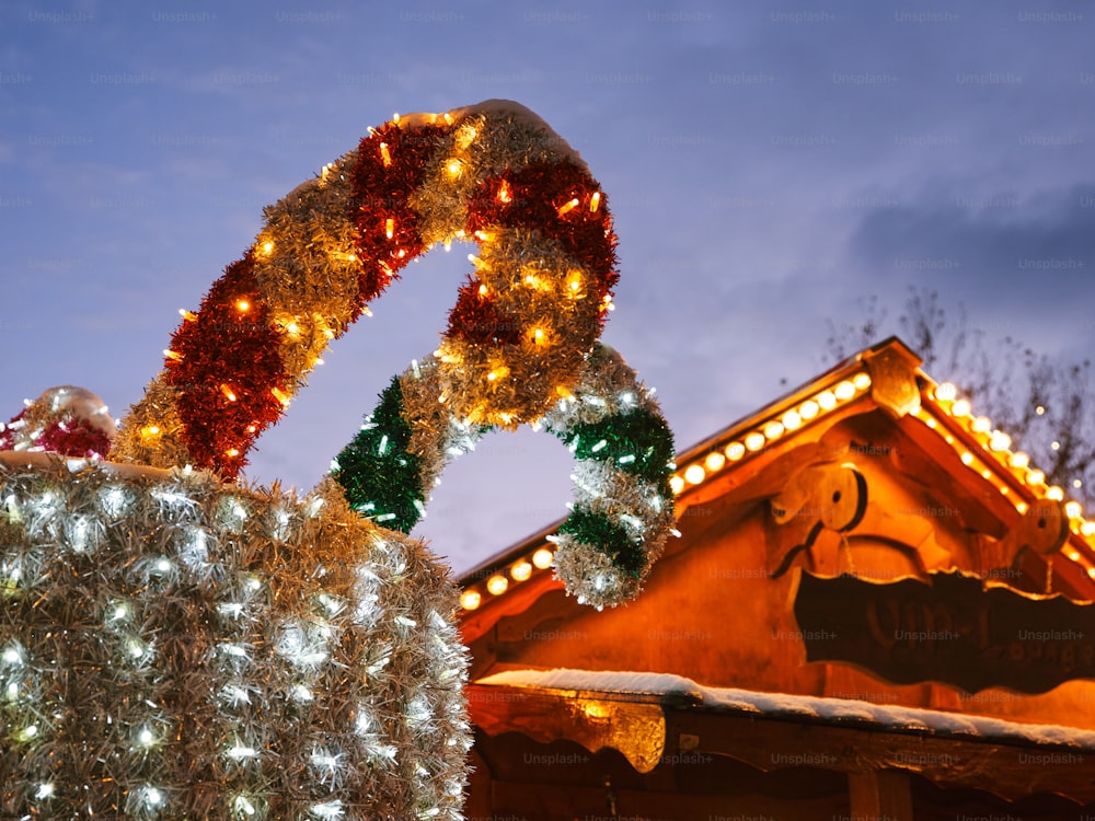 a christmas display with lights and decorations on top of a building