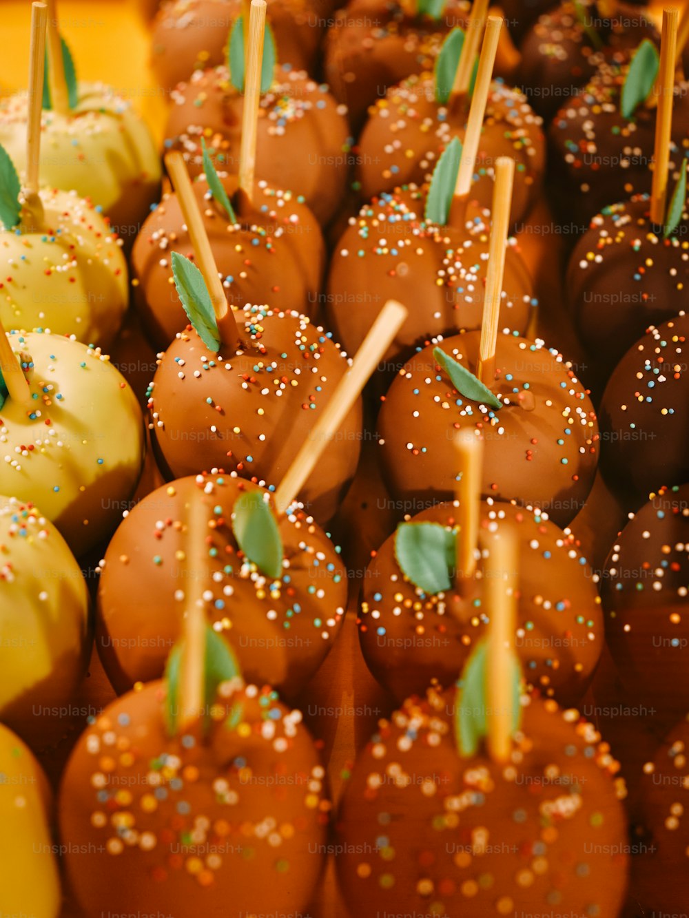 a close up of a tray of chocolate covered apples