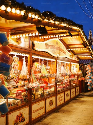 a christmas market with lights and decorations on display