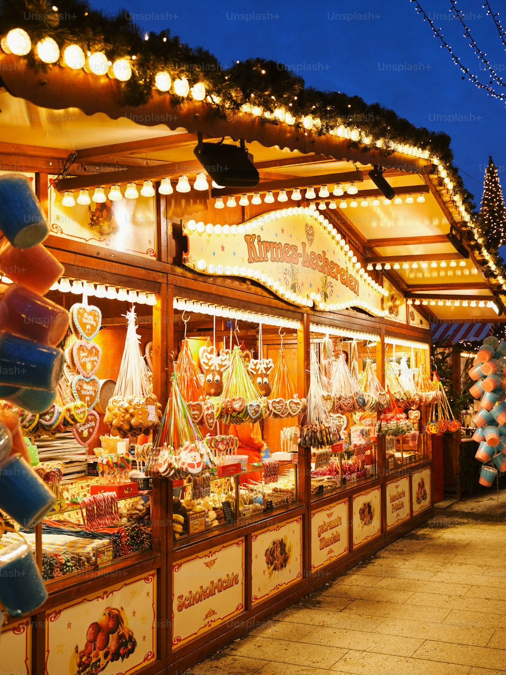 a christmas market with lights and decorations on display