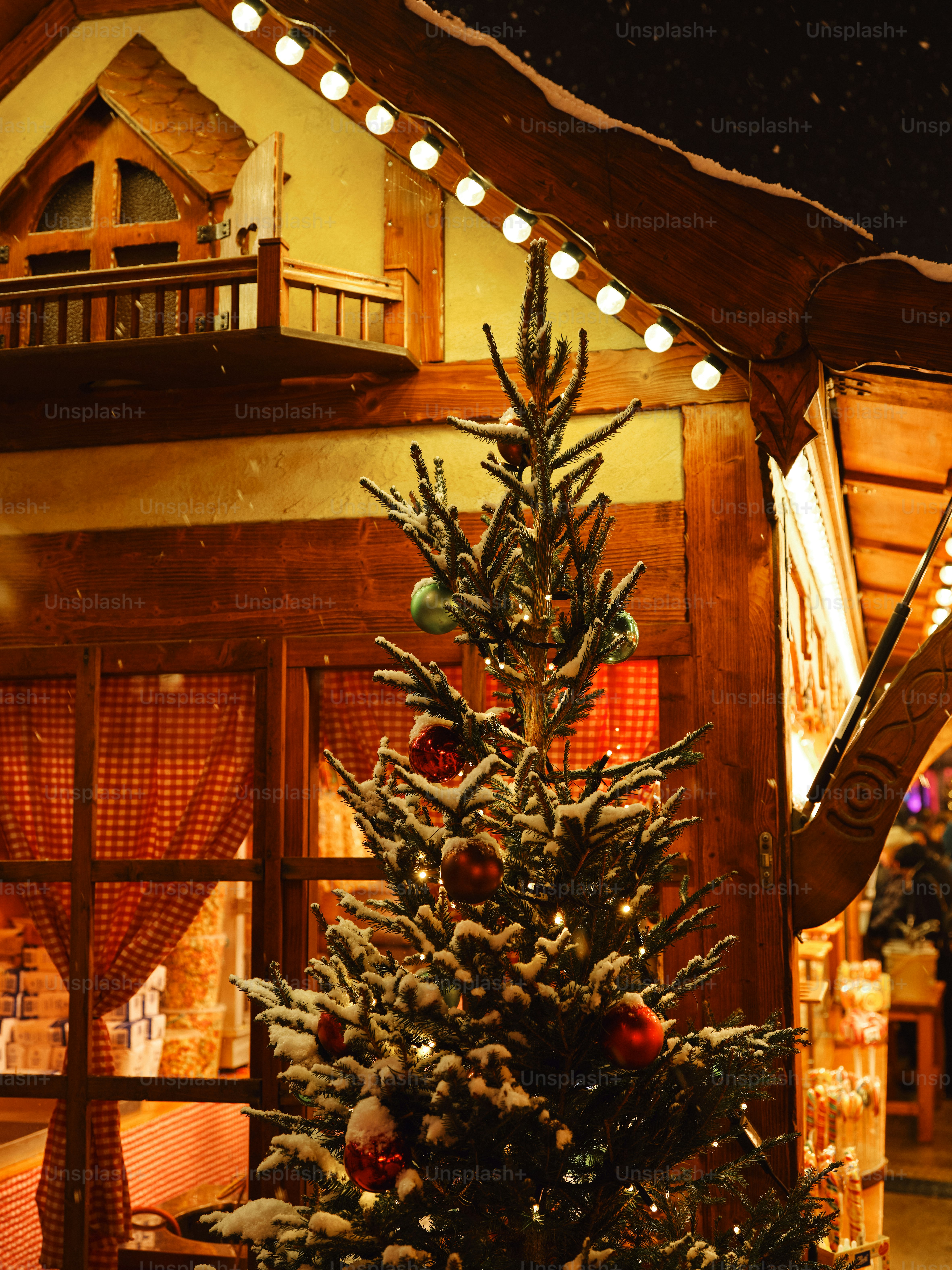 a decorated christmas tree in front of a house
