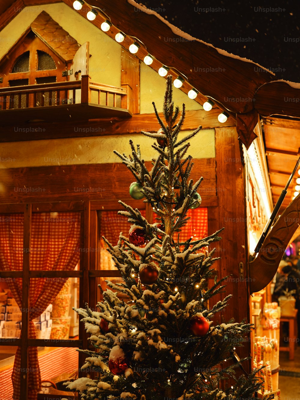 a decorated christmas tree in front of a house