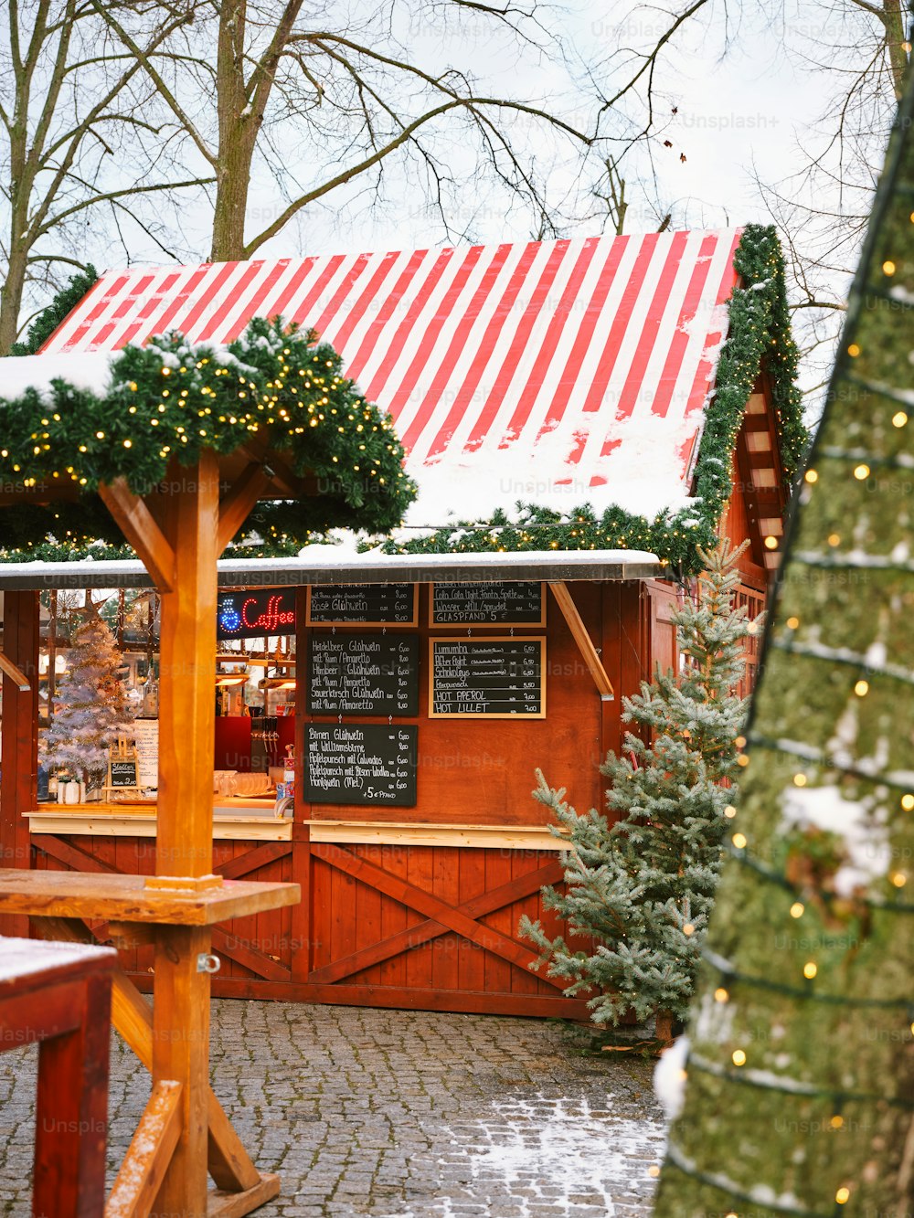 ein kleines Restaurant mit einem Weihnachtsbaum davor