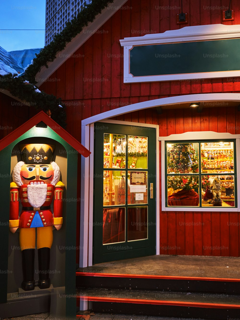a large nutcracker statue in front of a red building